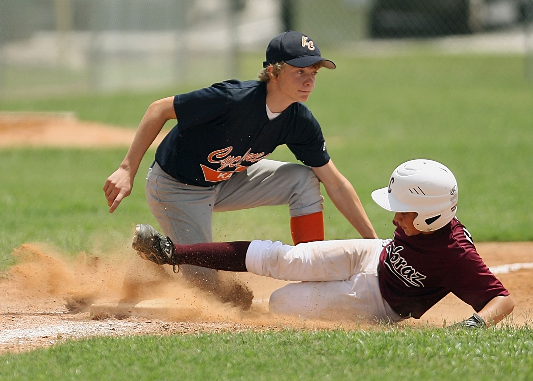 Teenage baseball player taking a swing