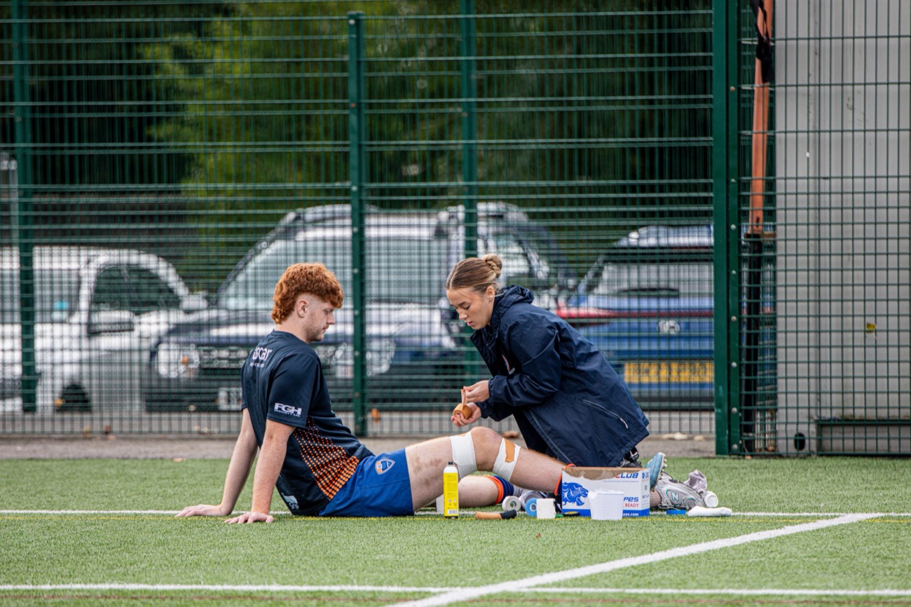 Coach attending to an injured player