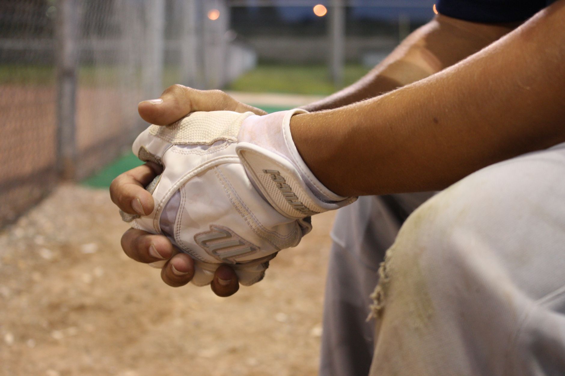 Well-worn baseball glove resting on a bench