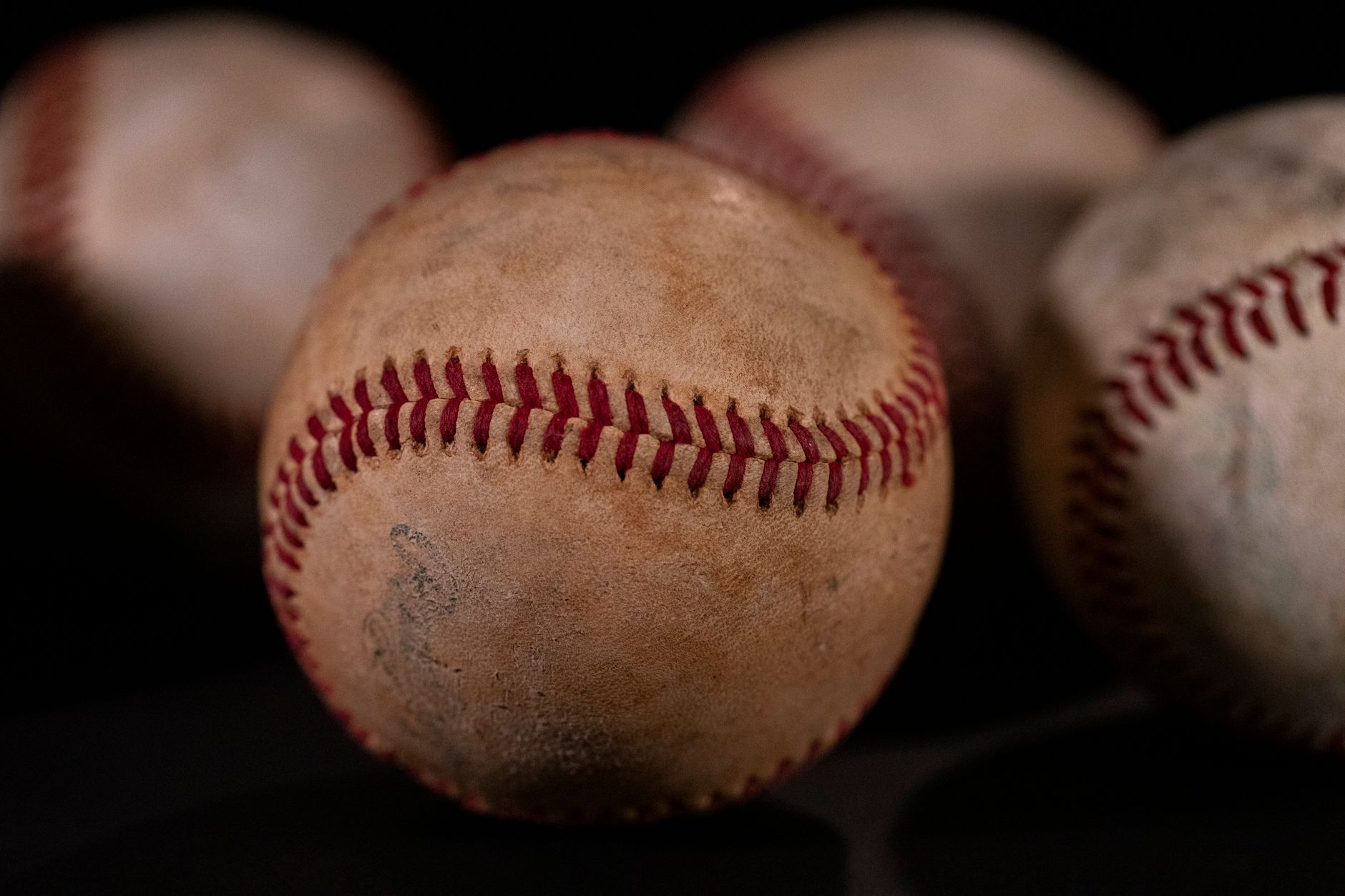 Young player breaking in a new baseball glove