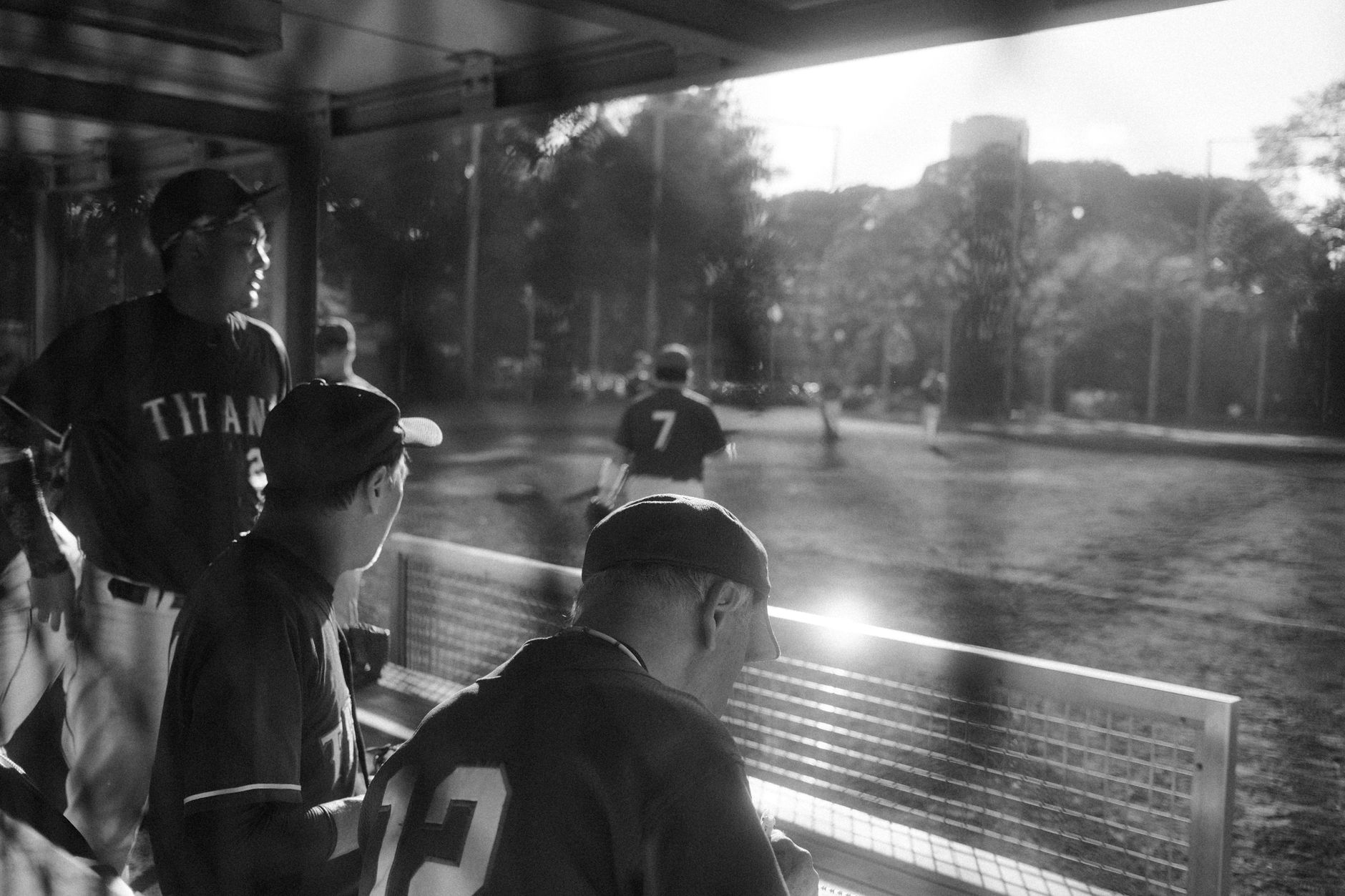Player sitting quietly in the dugout between innings