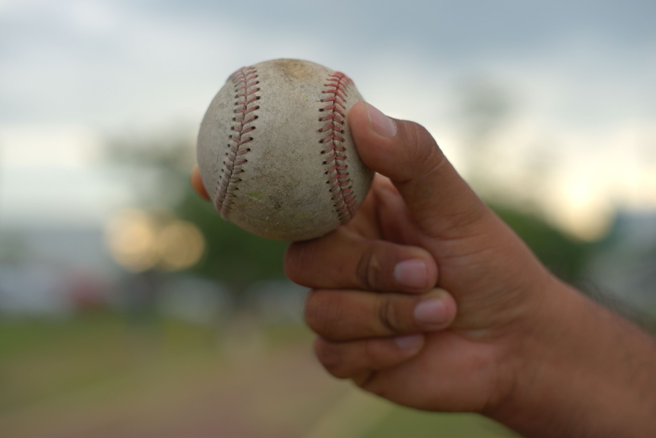 Close-up of a hand on baseball seams