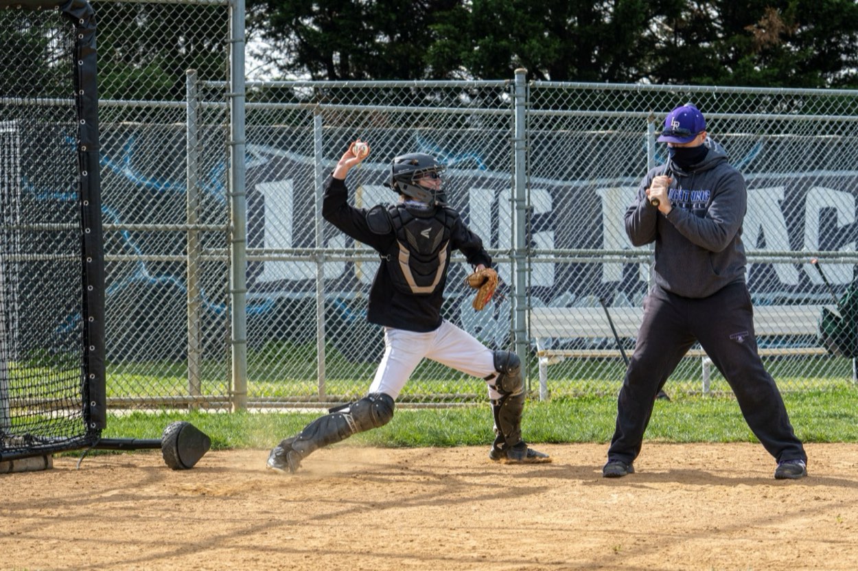 Throwing a ball against a wall for fielding practice
