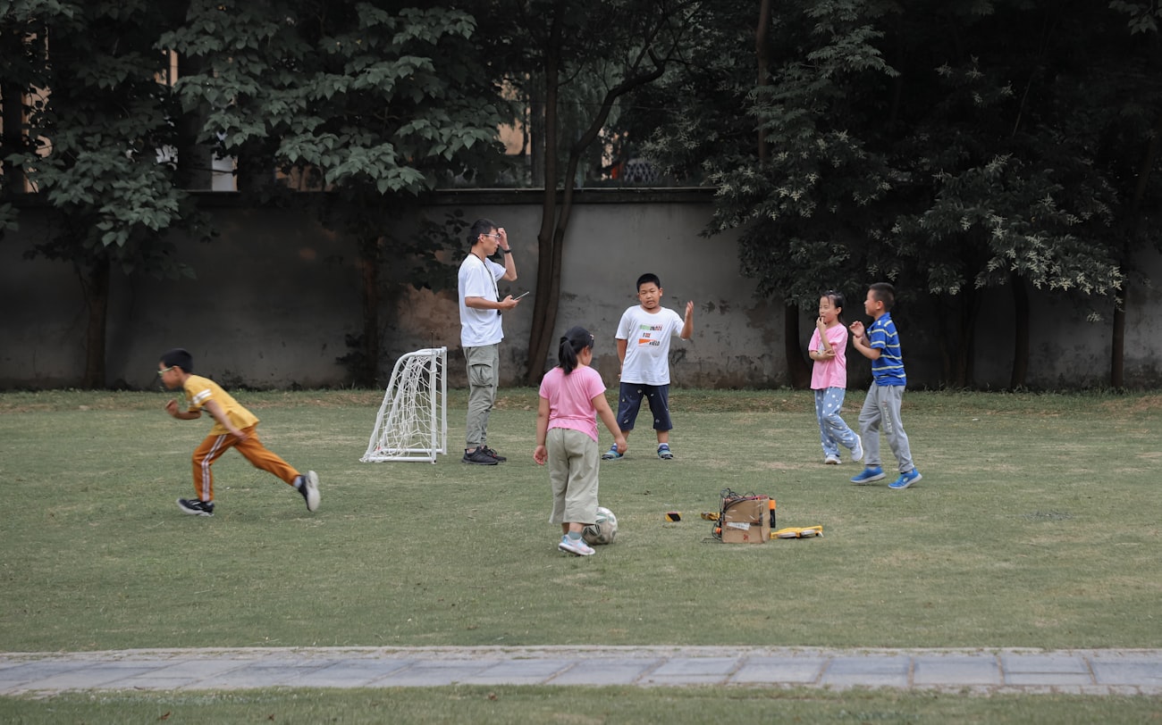 Young athlete playing football on a grass field