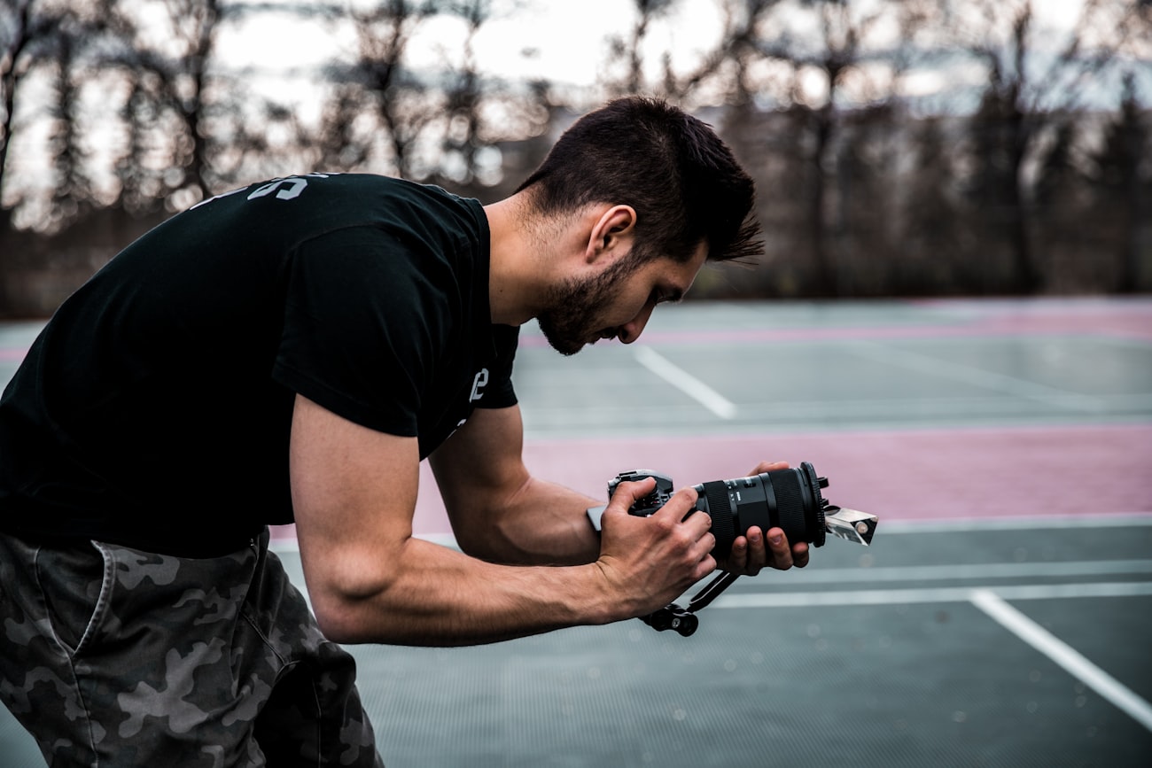 Tripod set up beside a baseball field
