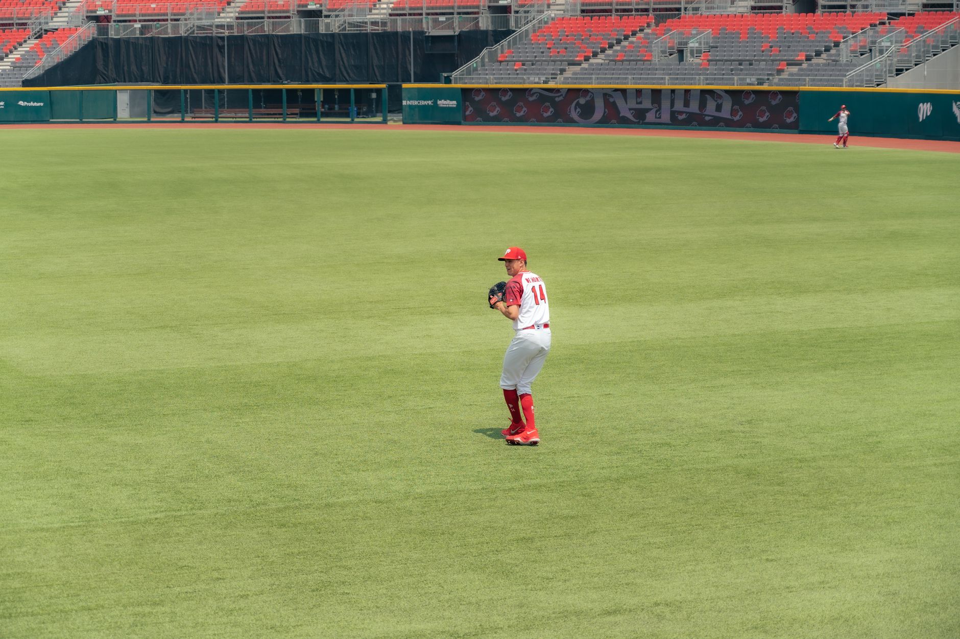Coach taking notes on a clipboard at a baseball game