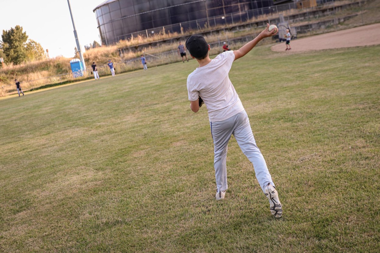 Left-handed pitcher delivering a pitch