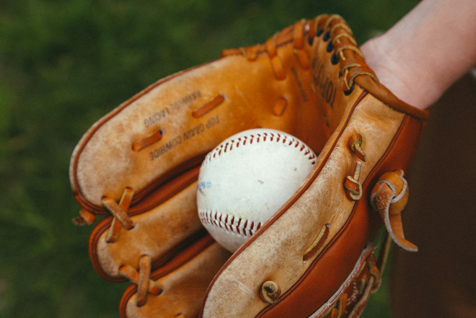 Baseball equipment laid out including bat, glove and helmet