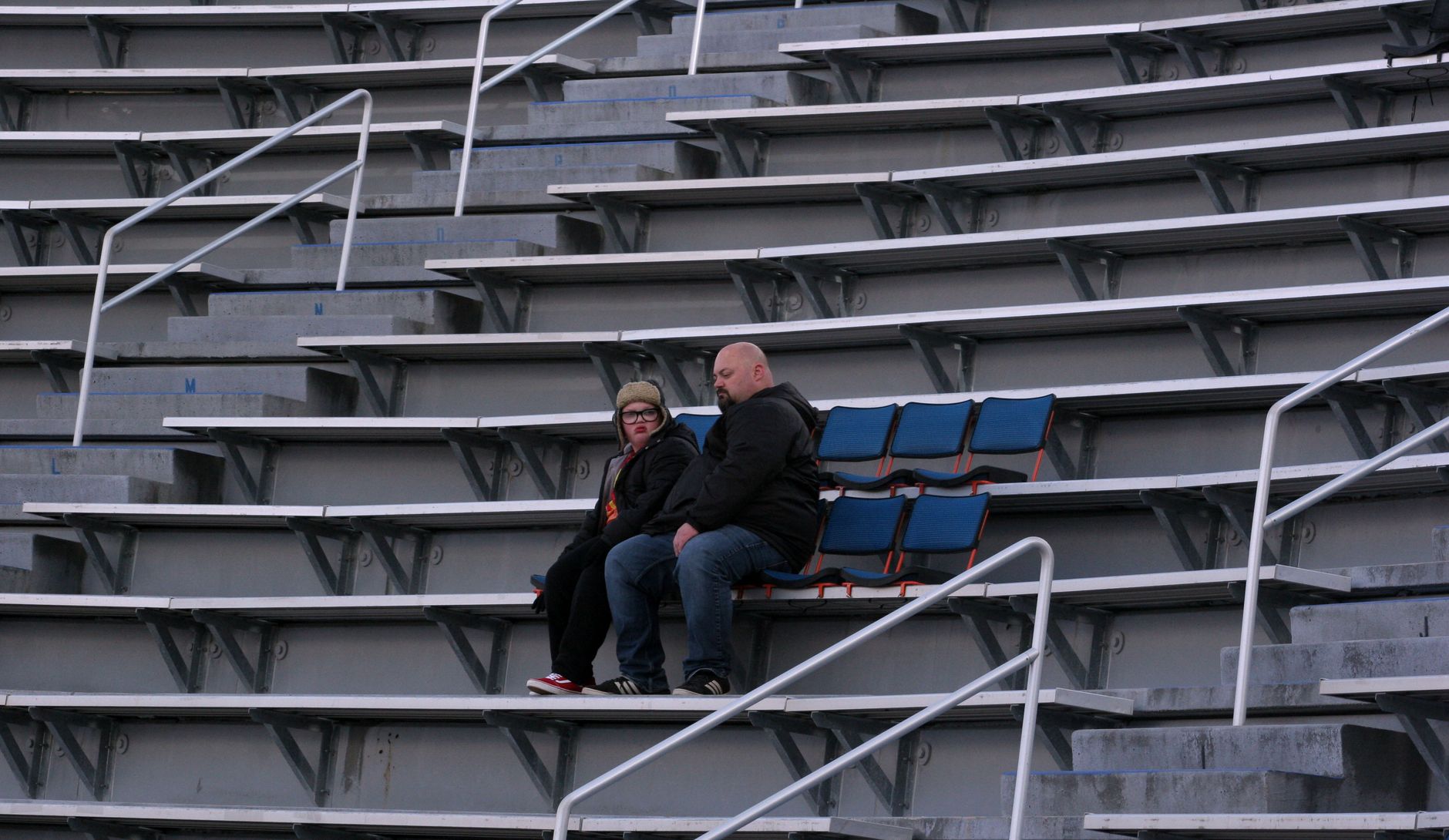 Spectators cheering at a youth baseball game