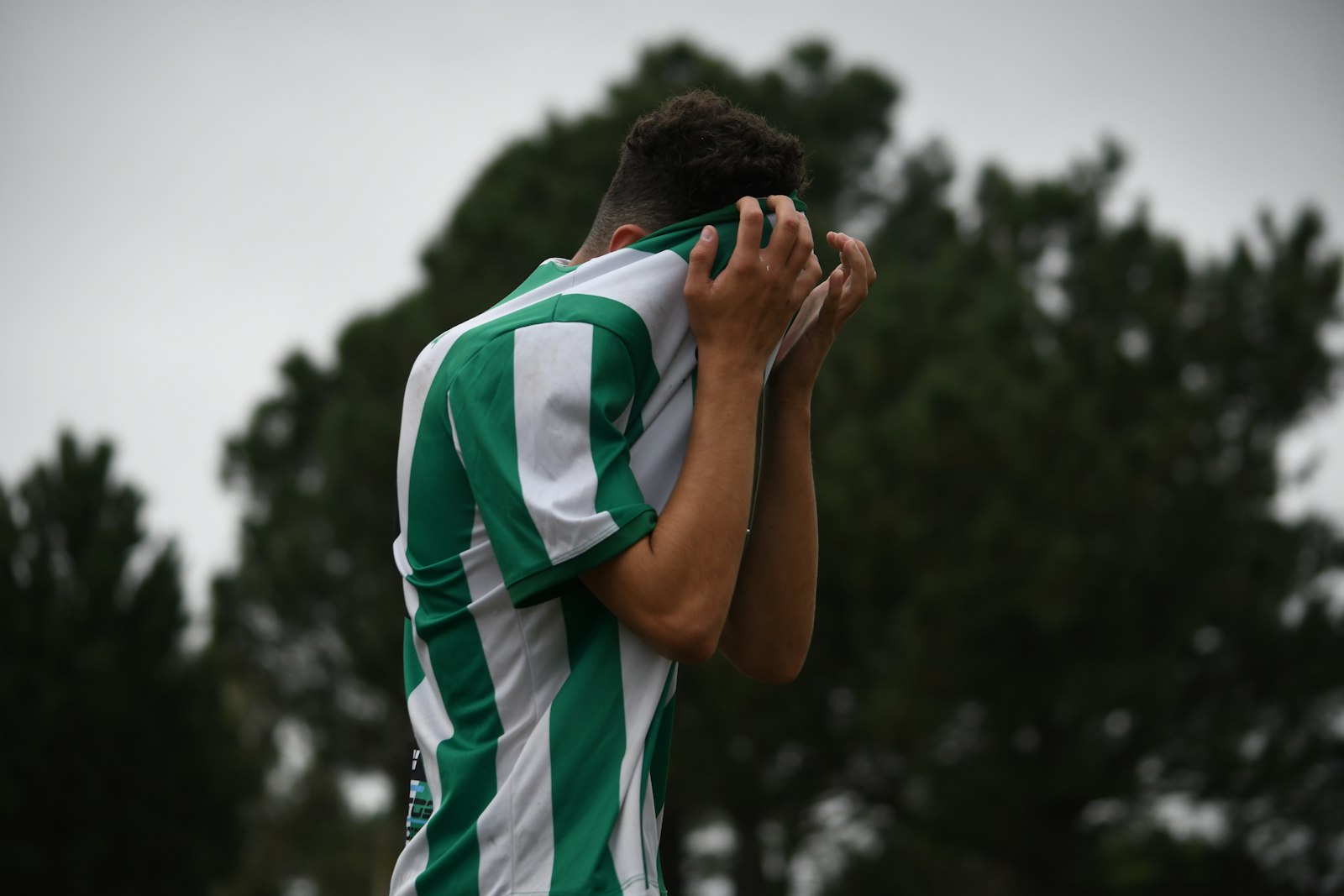 Young athlete sitting alone after disappointing news