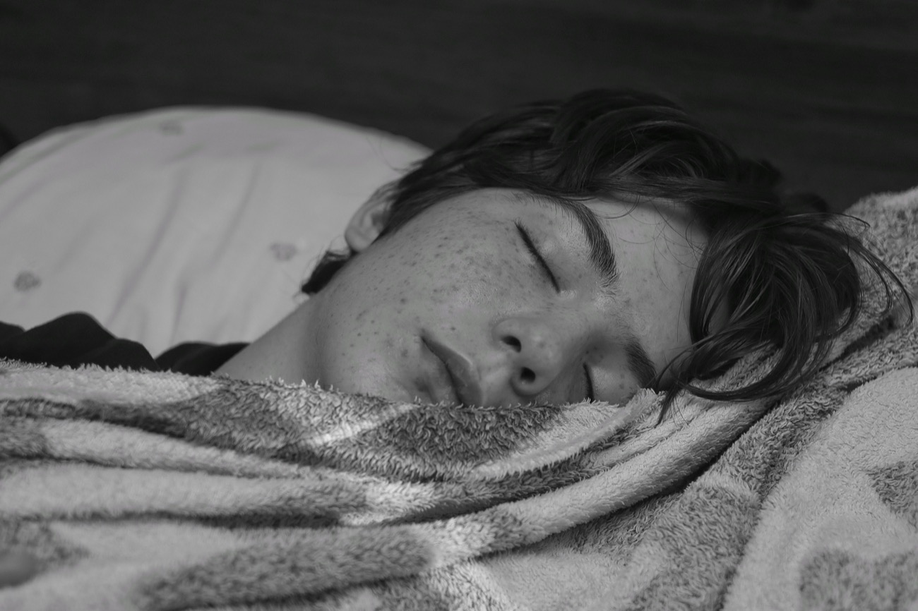 Alarm clock beside a bed in the morning