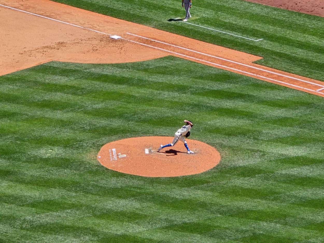 Side view of a young pitcher throwing